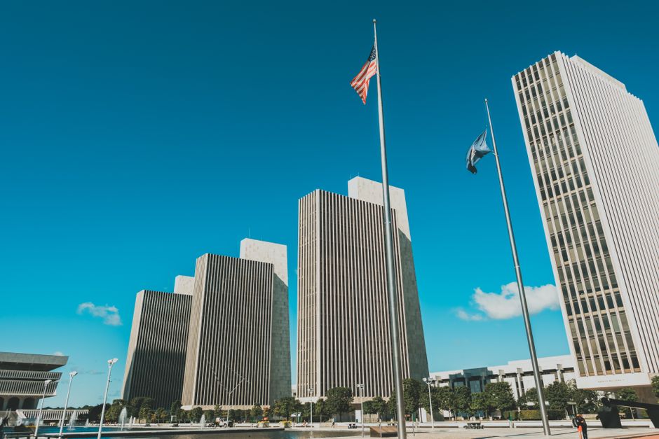 Modern skyscrapers towering at Empire State Plaza in Albany, New York under a clear blue sky.