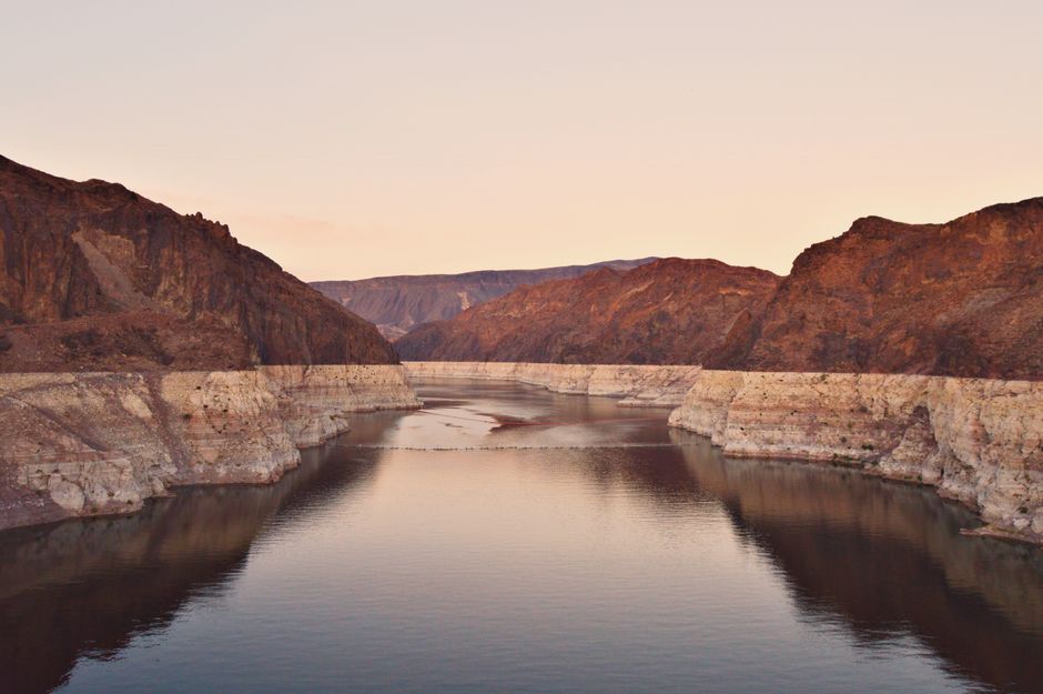 A stunning view of Lake Mead at sunset, showcasing the rocky desert landscape in Boulder City, Nevada.