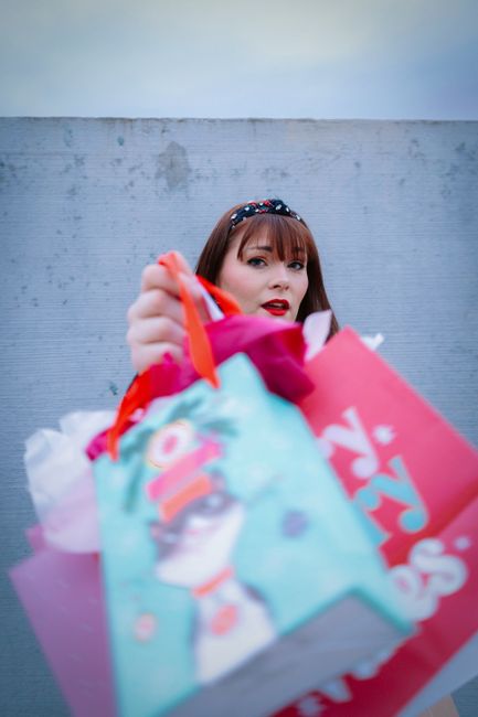 A woman holding colorful shopping bags during holiday season in Broomfield, Colorado, USA.