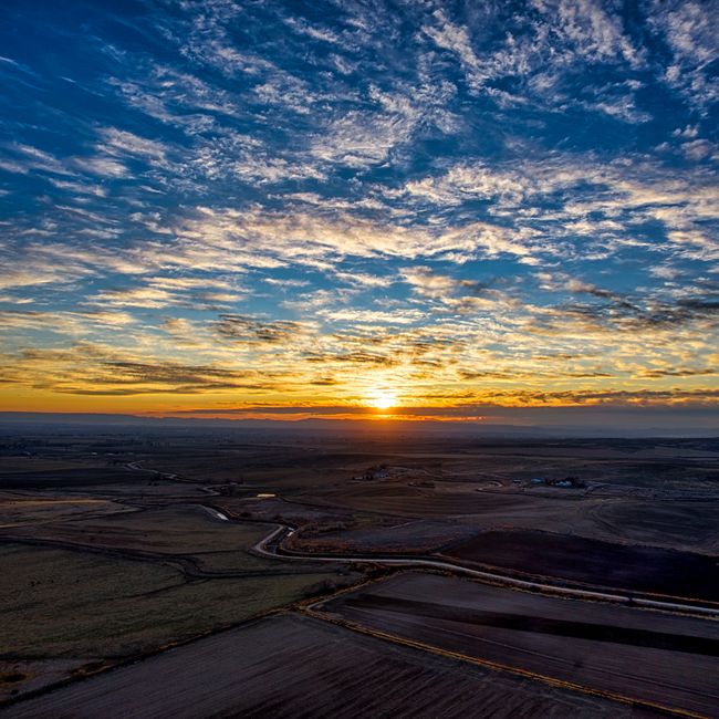 Beautiful sunset with expansive cloudscape over fields in Caldwell, Idaho.