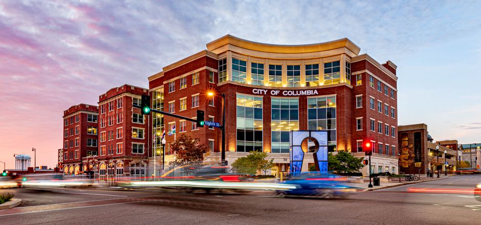 Colorful twilight view of downtown Columbia, Missouri capturing urban life and modern architecture.