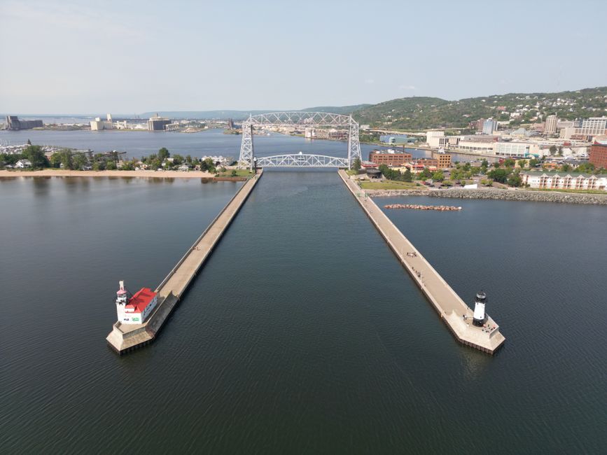A stunning aerial shot of Duluth's iconic Aerial Lift Bridge and surrounding harbor on a clear day.