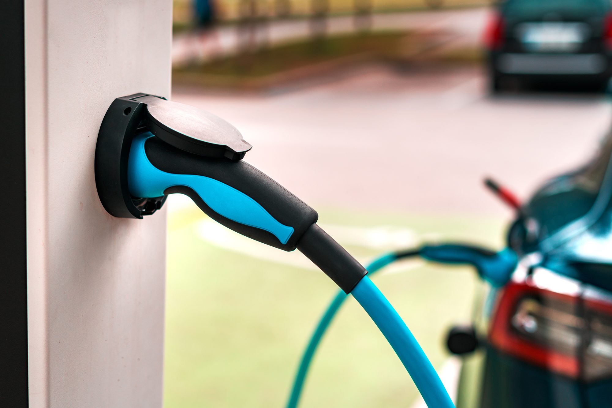 Electric car charging plug at a charging station