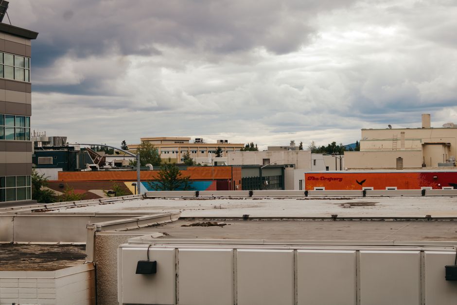 View of commercial buildings under a cloudy sky in Fairbanks, Alaska, showcasing urban architecture.