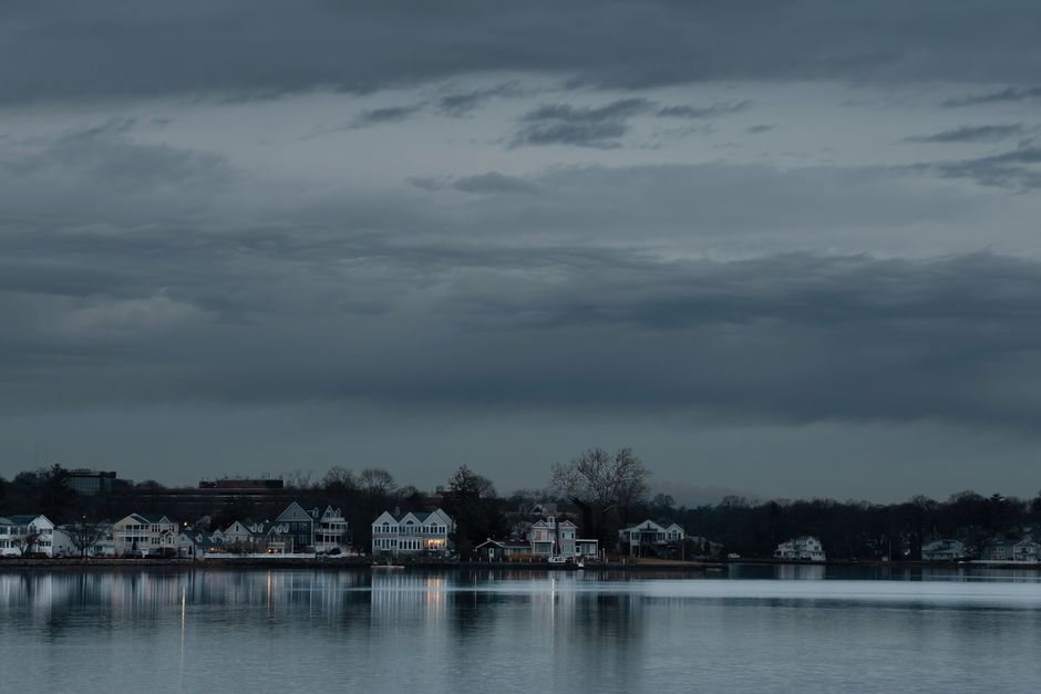 Serene dawn view of Stamford, Connecticut skyline reflecting on the water. Calm and tranquil atmosphere.