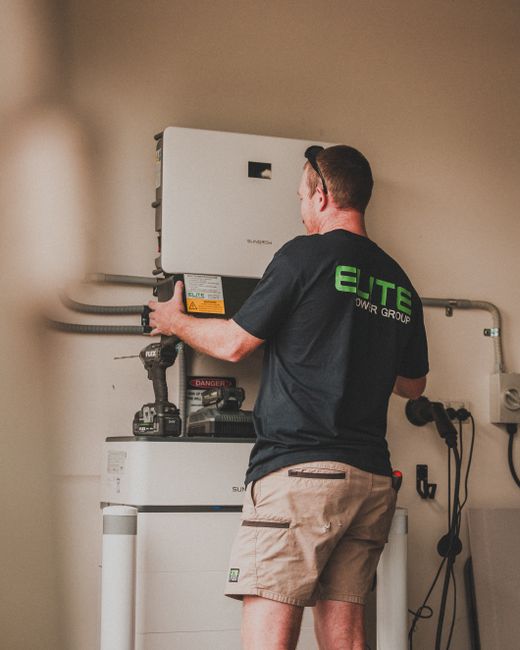 Expert technician installing a home solar battery system for energy storage.