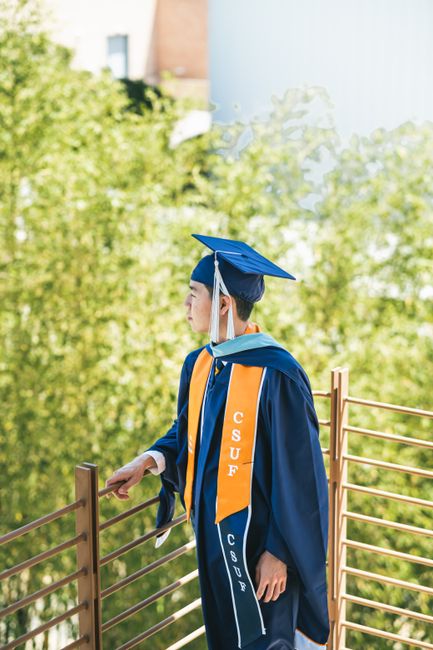 Young man in graduation attire at California State University, Fullerton.