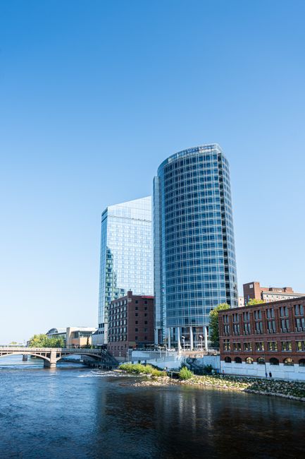 Stunning view of the Grand Rapids skyline with modern glass buildings along the river on a clear day.