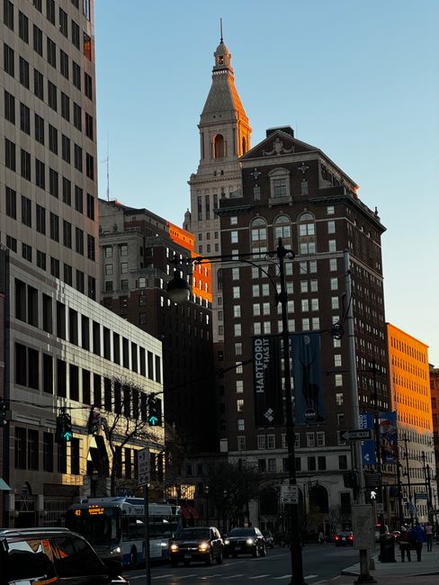 A view of classic architecture in downtown Hartford during sunset with a warm glow.