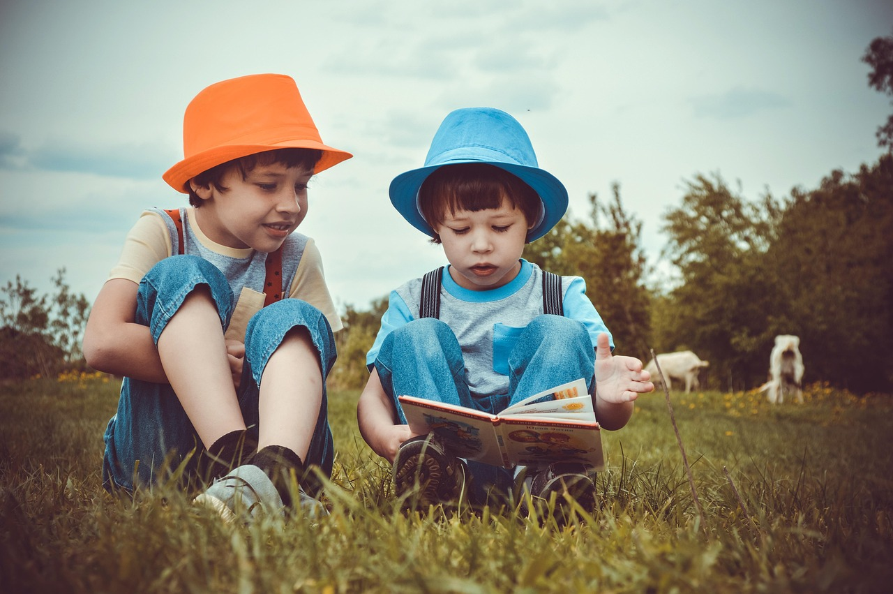 Boys, kids, reading, summer, brothers, brothers and sisters, outdoors, meadow, childhood, family, nature, grass, village, river bank, fairy tales, book, children read a book, the story, listen, friend