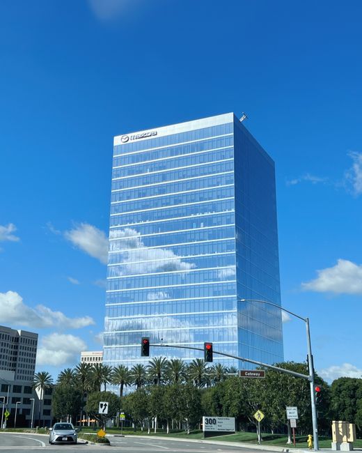 Skyscraper in Irvine, California with blue skies and urban environment.