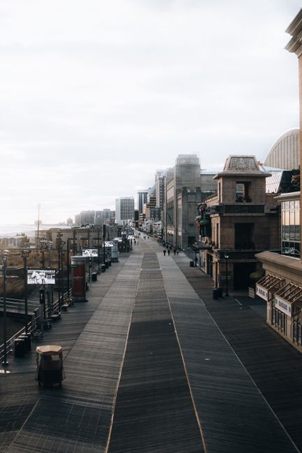 A coastal city boardwalk with skyline. Calm, urban landscape during the day.