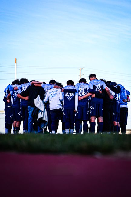 A high school soccer team huddles together in Lancaster, California.