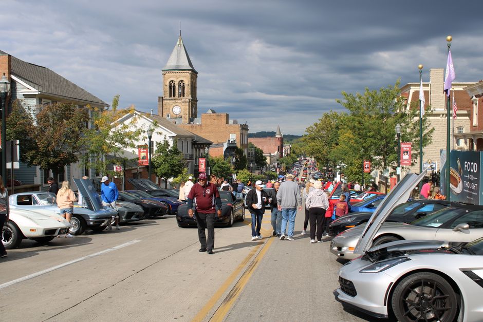 Crowds enjoy a vibrant car show on a sunny day in Lancaster, Ohio.