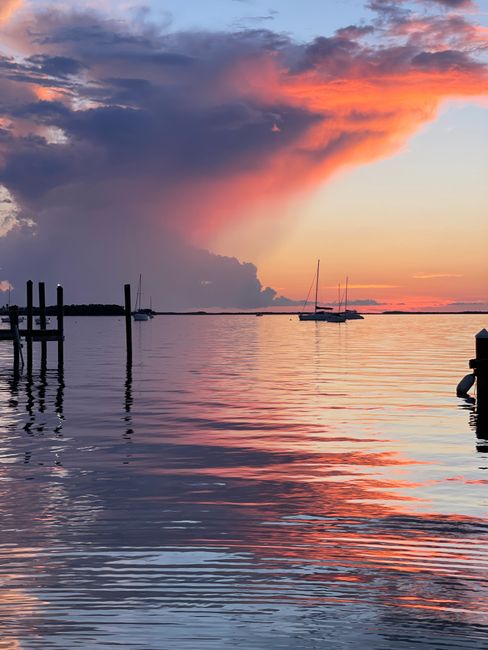 Beautiful sunset with sailboats on the calm waters of Key Largo, Florida.