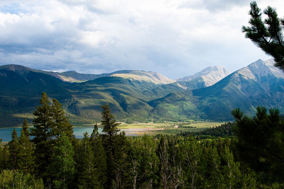 Breathtaking landscape of Twin Lakes with surrounding mountains and lush forest in Colorado.