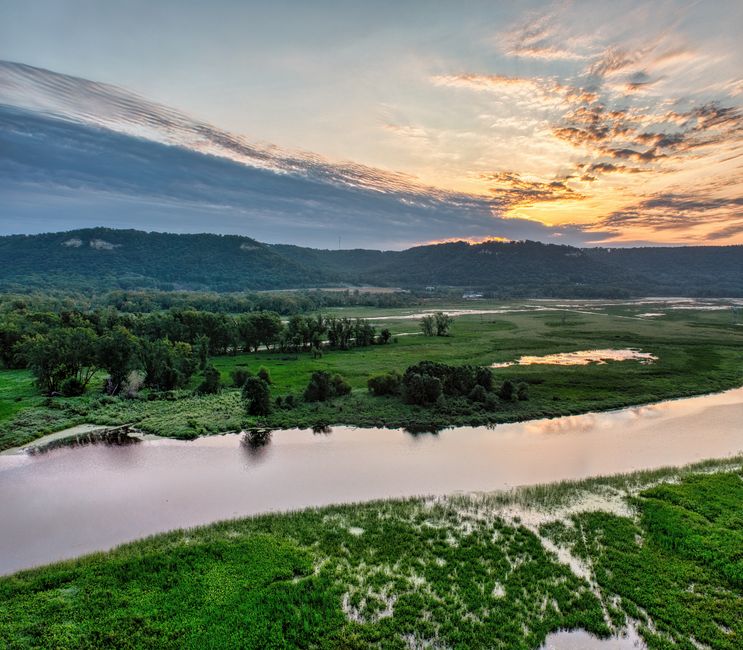 Stunning sunset view over the Mississippi River and lush green landscape in Nelson, Wisconsin.