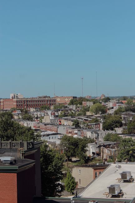 Skyline view of Baltimore's residential rooftops showcasing urban cityscape and greenery.
