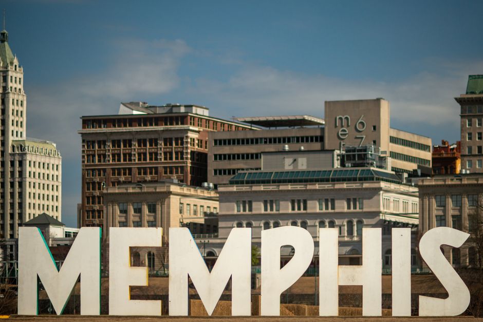 View of the Memphis sign set against the historic city skyline, showcasing iconic architecture.