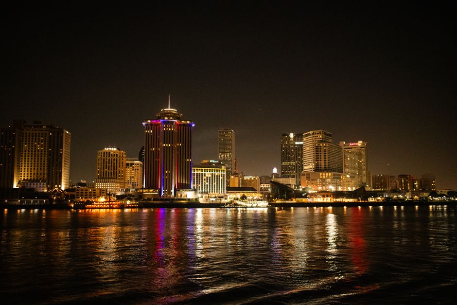 Captivating night shot of New Orleans skyline reflecting on the Mississippi River.