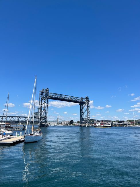 Boats docked by the Memorial Bridge with clear blue skies and calm waters.