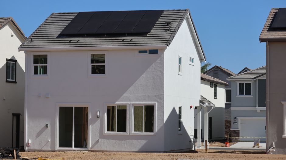 Newly constructed eco-friendly home, featuring rooftop solar panels for sustainable energy.