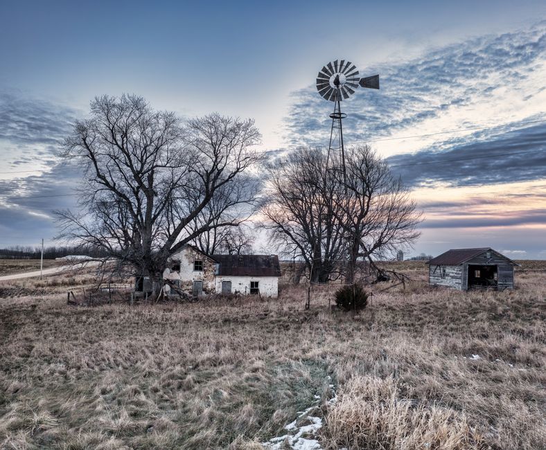 Rural winter scene with a barn and windmill on the northern plains