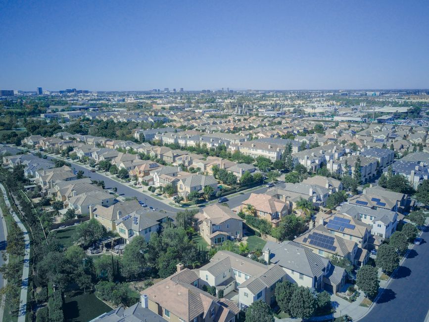 Aerial view of suburban homes with rooftop solar panels