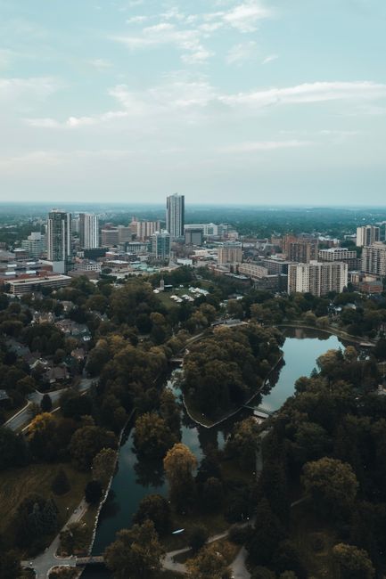 Aerial shot of downtown Kitchener, Ontario, featuring urban skyline and lush parks.