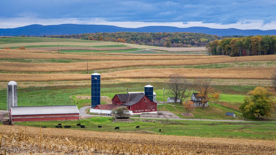 Idyllic farm scene with silo and barn in rural Pennsylvania fields.