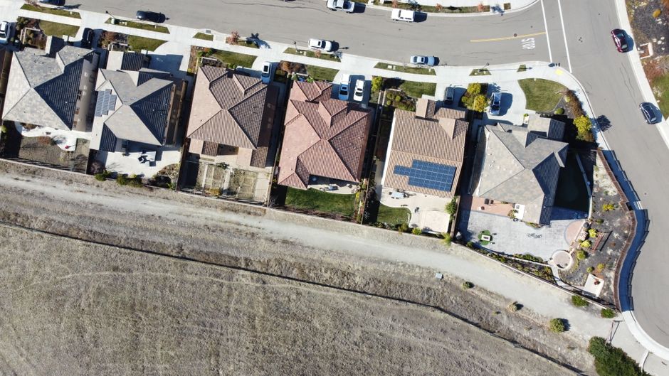 Overhead view of suburban houses with rooftop solar panels