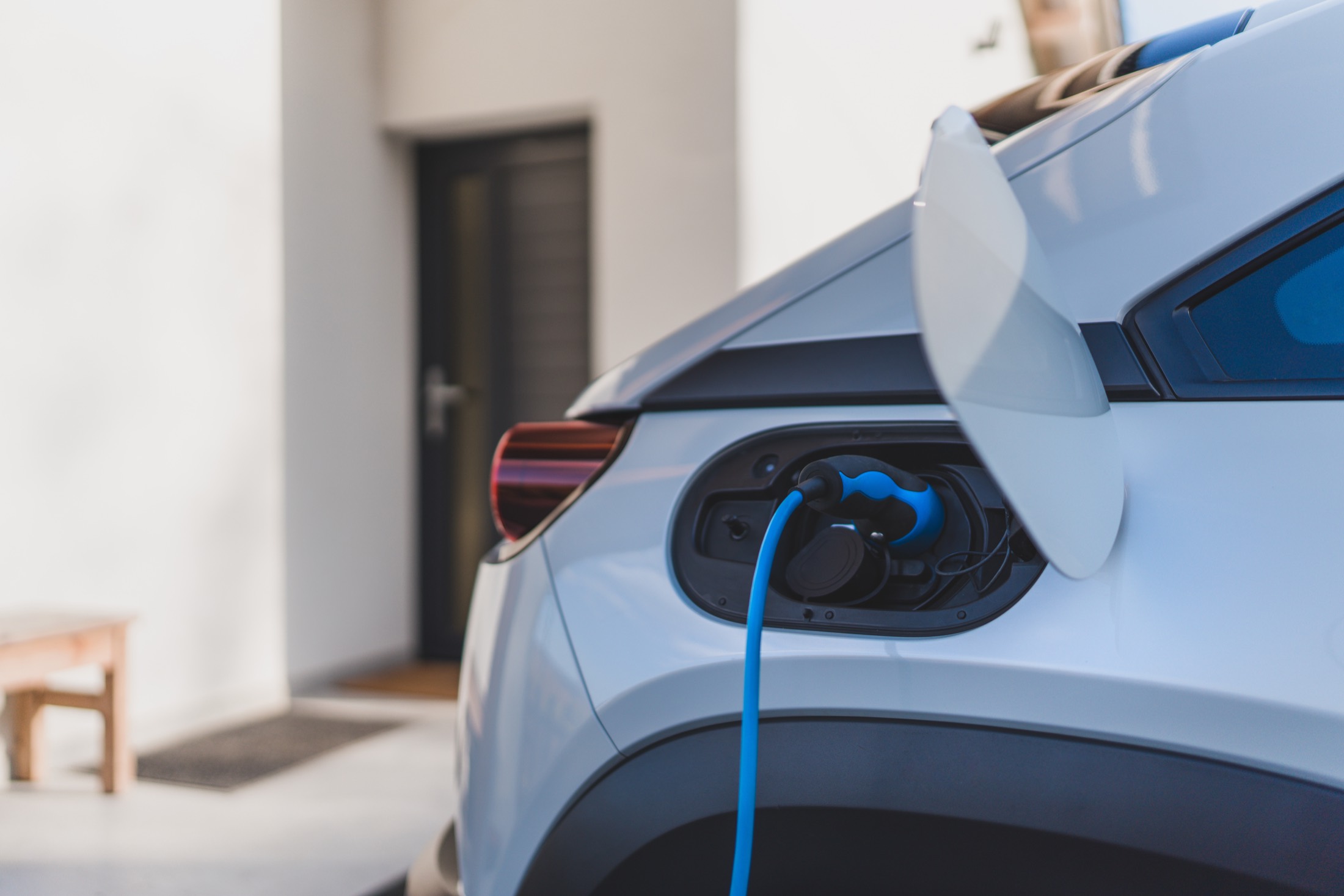 Electric car plugged in to charge at a home