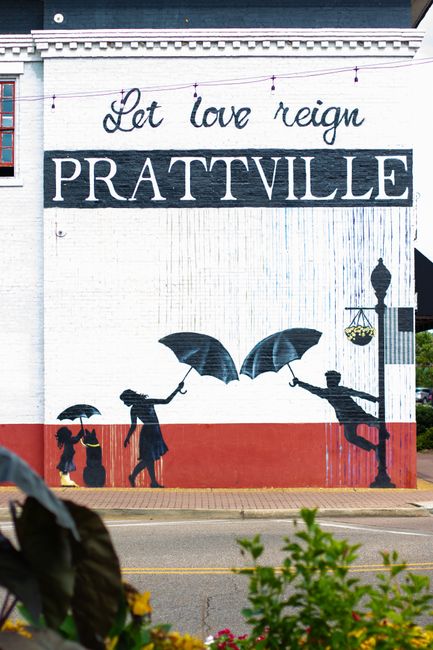 Vibrant street mural in Prattville, Alabama, celebrating 'Let love reign'.