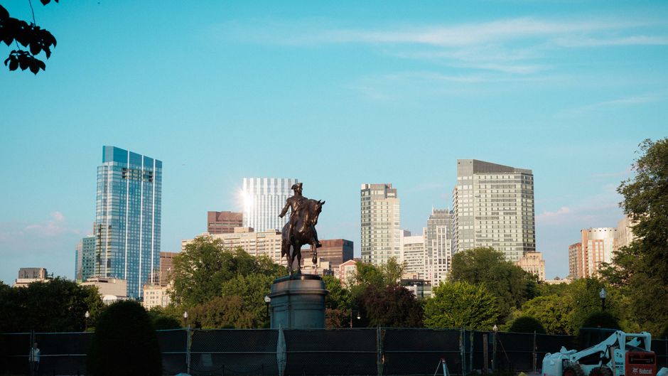 Paul Revere statue with Boston's modern skyline in the background. Captures iconic blend of history and urban life.
