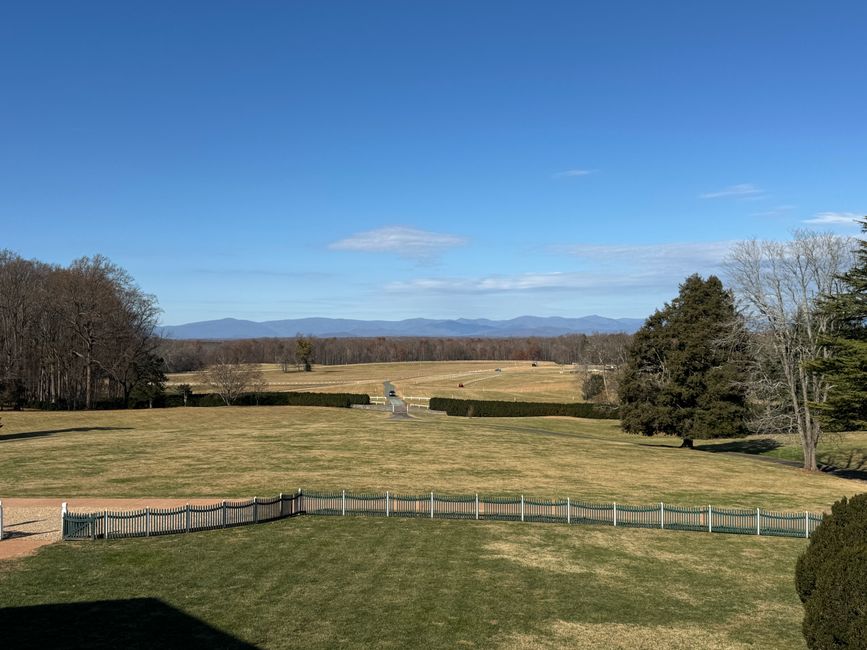 A peaceful landscape view from Montpelier with distant mountain scenery under a clear blue sky.