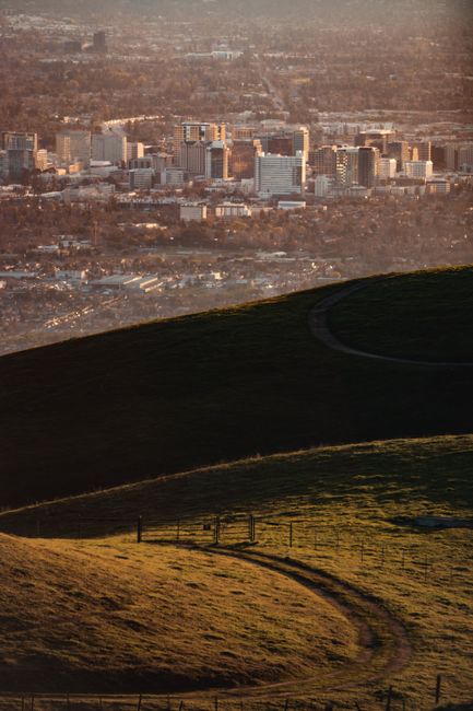 Breathtaking view of San Jose's skyline during sunset, viewed from rolling hills.