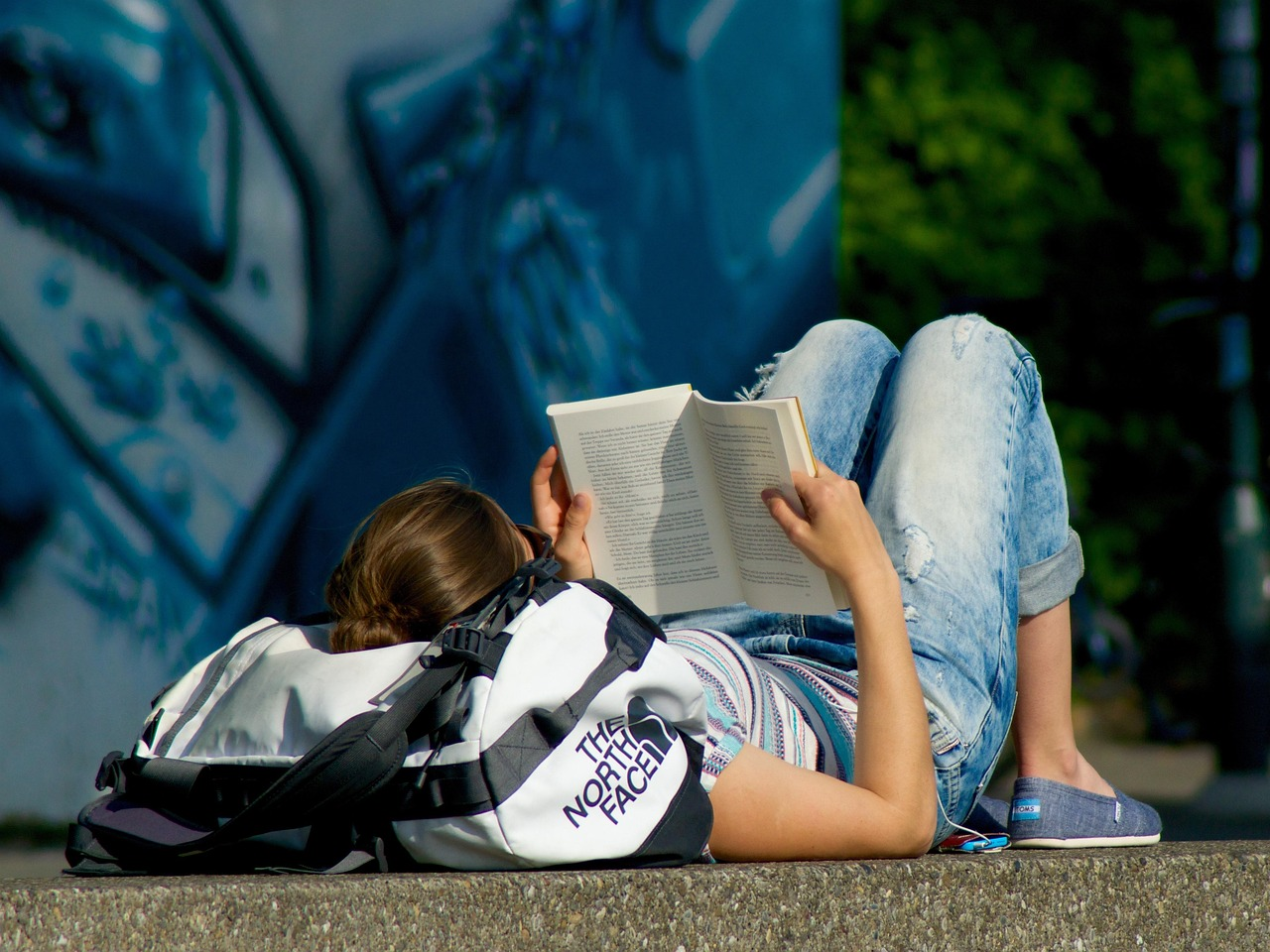 Read a book, woman, young, on the ground, lying