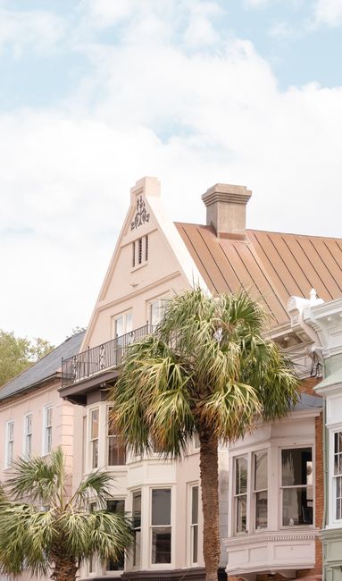 Charming pastel buildings and palm trees in historic Charleston, SC, capturing classic Southern architecture.