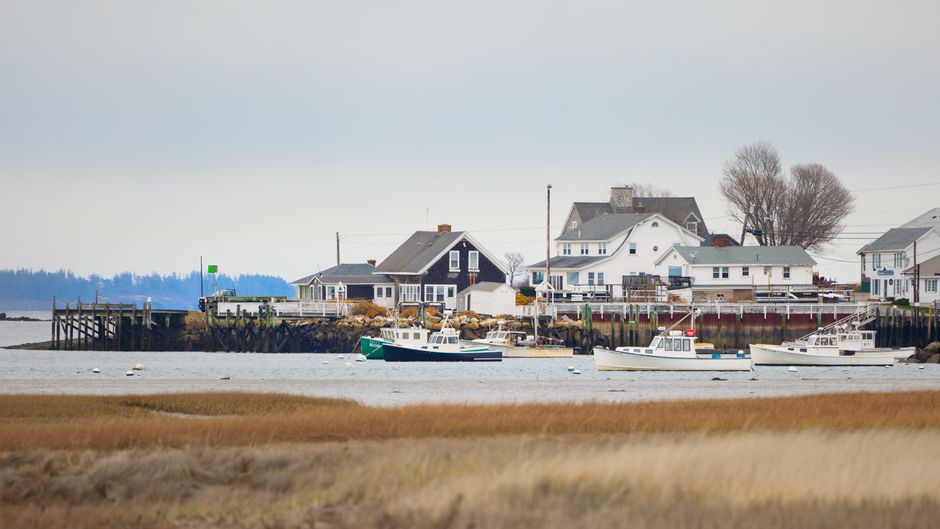 Quaint coastal town view with boats and homes in Biddeford, Maine, USA.