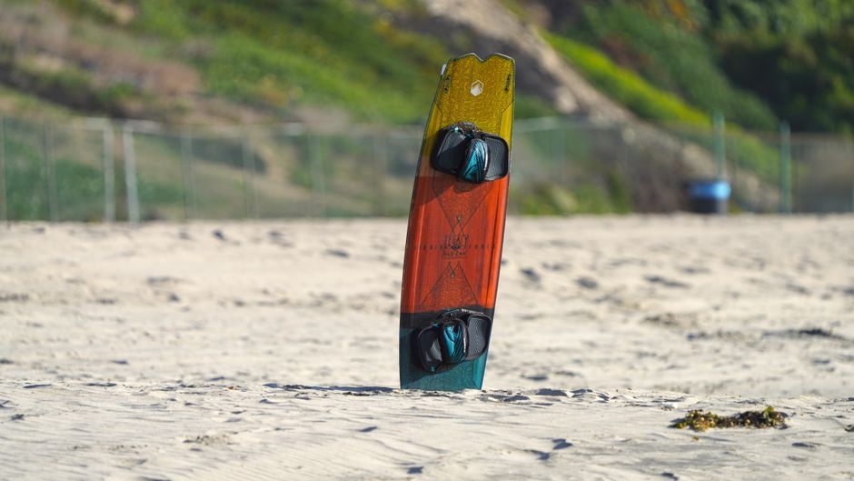 Vibrant surfboard standing on sandy beach in Torrance, California.