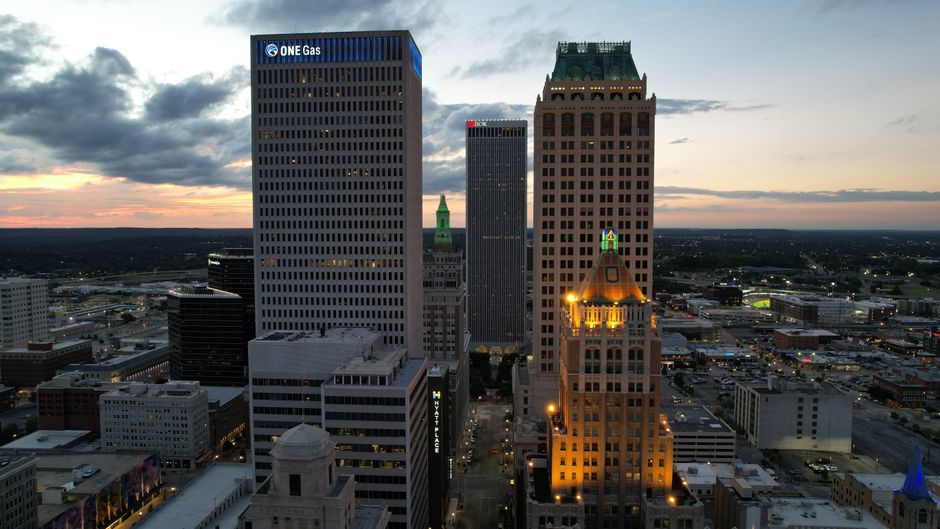 Explore Tulsa's downtown skyline at twilight with stunning architecture and vibrant evening lights.